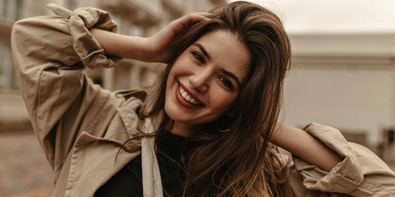 attractive woman smiling Want To Be More Attractive? Stop Doing These 8 Things, ASAP