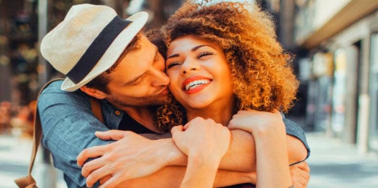 4 Ways To Build Attraction In Your Relationship man kissing woman on the cheek