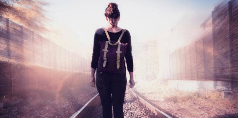 We Were Meant To Walk Away From Each Other woman with backpack walking away on train tracks