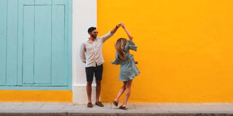 We Were The Definition Of 'Opposites Attract' And I Will Always Wonder What If a couple dancing on the street yellow wall background
