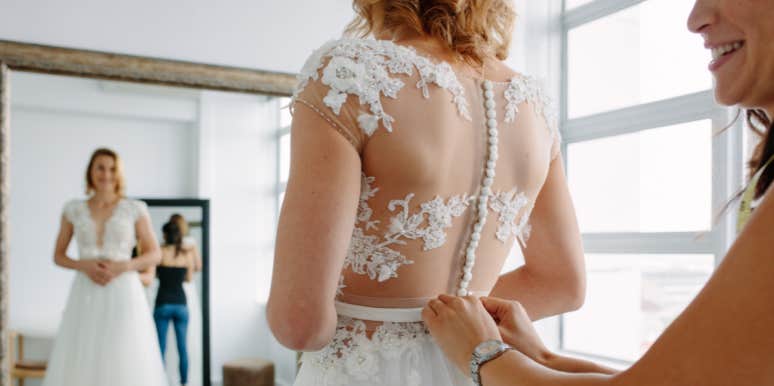 Woman getting wedding dress fitted