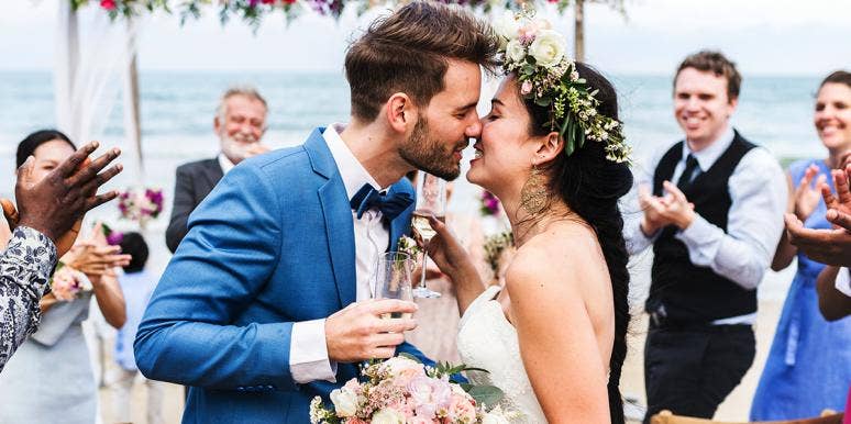 Why I'm Anti-Marriage, But Pro-Wedding couple kissing at wedding