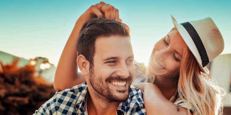 What Does Simp Mean? Slang Definition & Meanings woman wearing hat touching man's head smiling