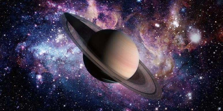 planet saturn in front of galaxy