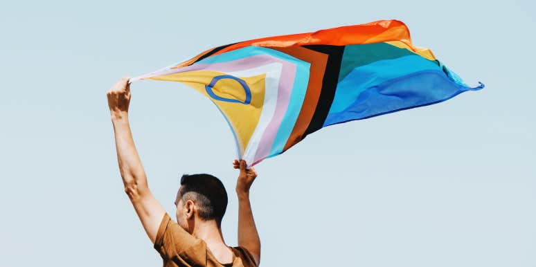 man waving an intersex pride flag