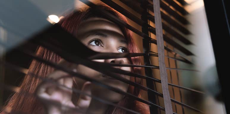 What Is Monophobia, And Why Do So Many People Have It? lonely woman looking out window