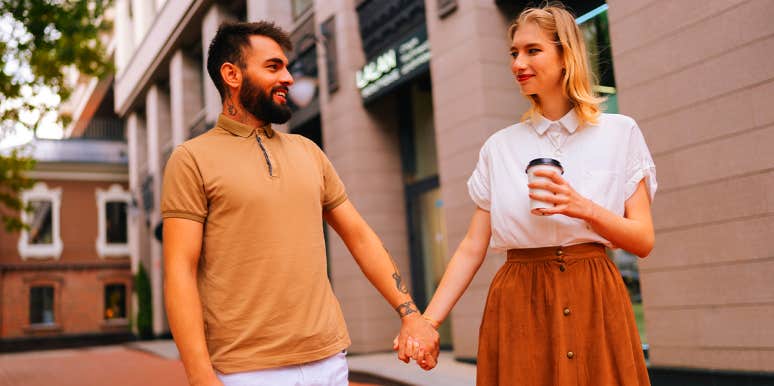 man and woman holding hands on date