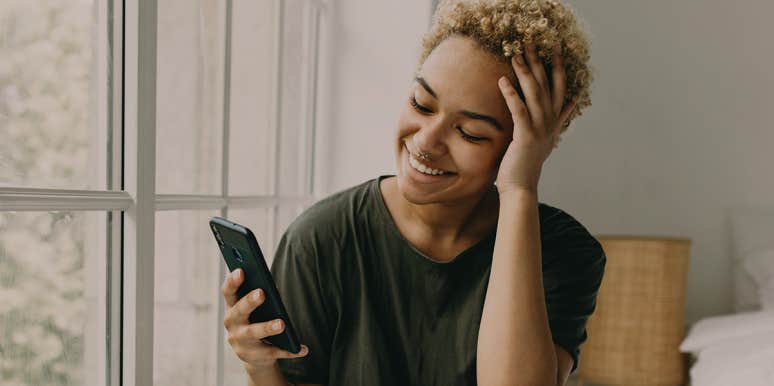 What It's Really Like To Be In An Open, Long-Distance Relationship woman texting boyfriend