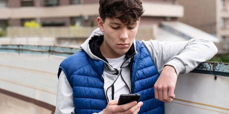 I Love My Son, But His Mental Illness Makes Me Not Like Him boy looking at iphone