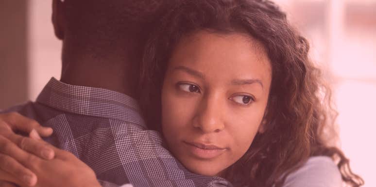 No, Micro-Cheating Isn't A Real Thing woman and man hugging, woman looks worried