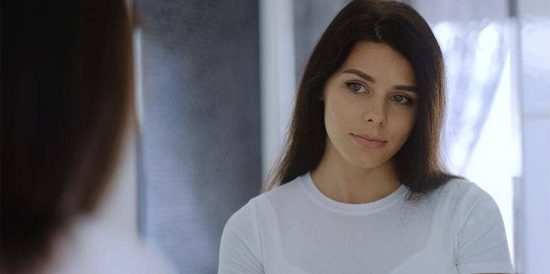 What Having A Cheating Father Taught Me About Men woman looking in mirror