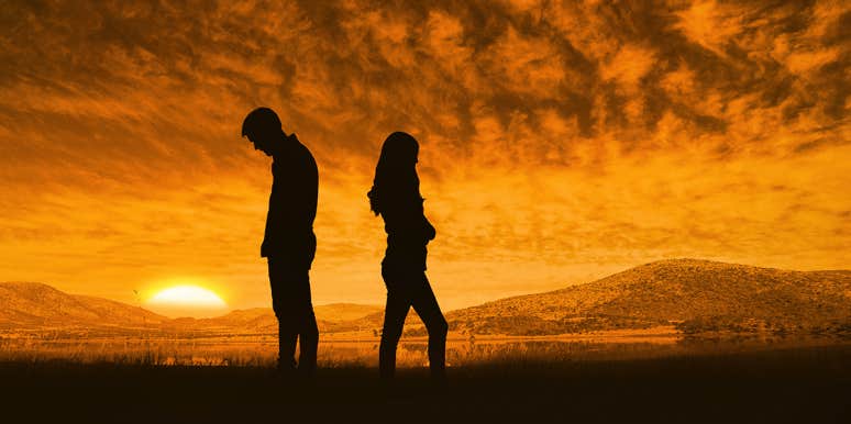 Why Taking A Break In A Relationship Is The Worst Thing Couples Do couple facing away from each other in sunset