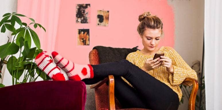 What To Do (And How To Stay Calm) When He Stops Calling Or Texting woman looking at her phone