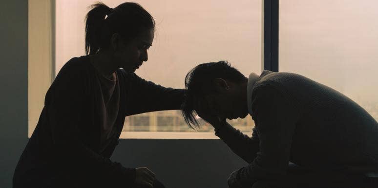 woman comforting man who is depressed