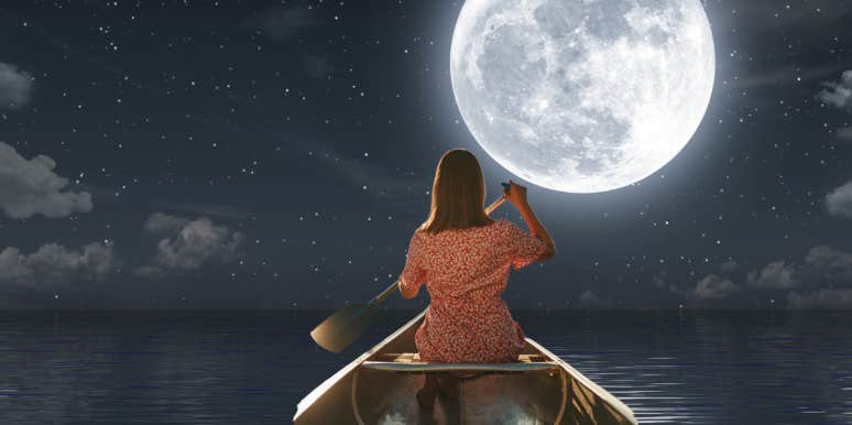 woman moving toward full moon