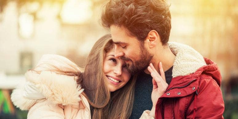 signs a man is in love with you happy couple in winter jackets