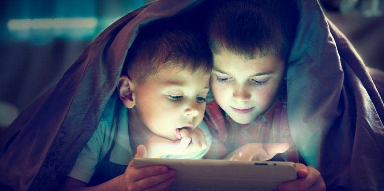 What Happened When My Sons Asked Me If Girls Have Orgasms two boys under blanket in dark