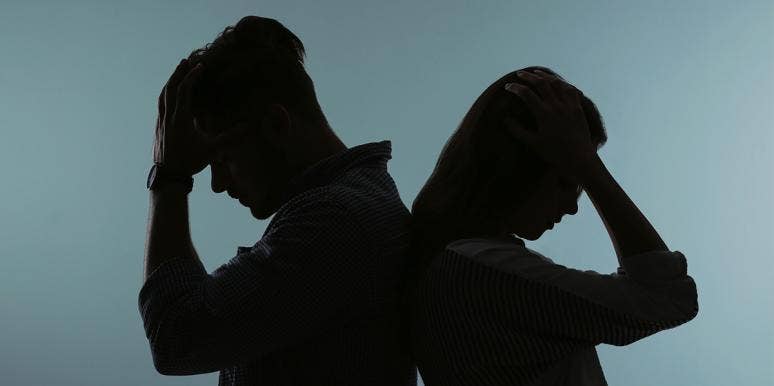 When To Break Up: 10 Signs It's Time To Let Go Of Your Relationship couple facing away from each other dark background