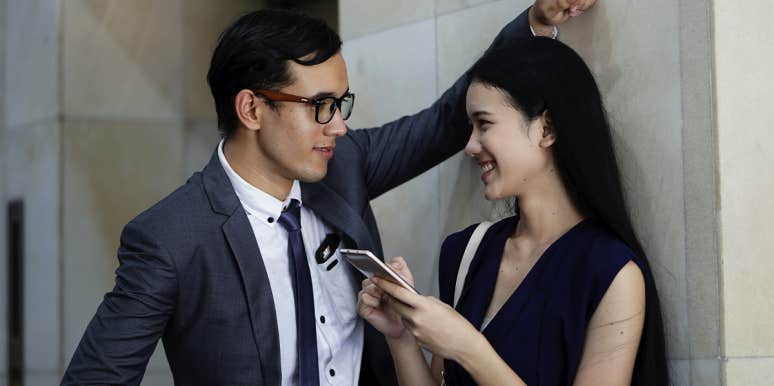 Why Having A Crush At Work Makes Your Spouse More Attractive man and woman flirting at work