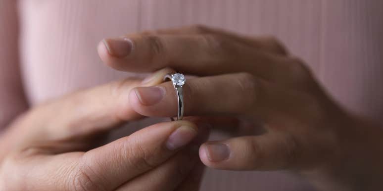 Why I Don't Wear My Diamond Ring Anymore, Even Though I'm Happily Married woman taking ring off