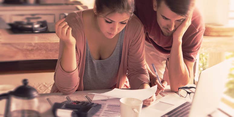 Why Lying About Money Is Way Worse Than An Affair couple looking at the bill