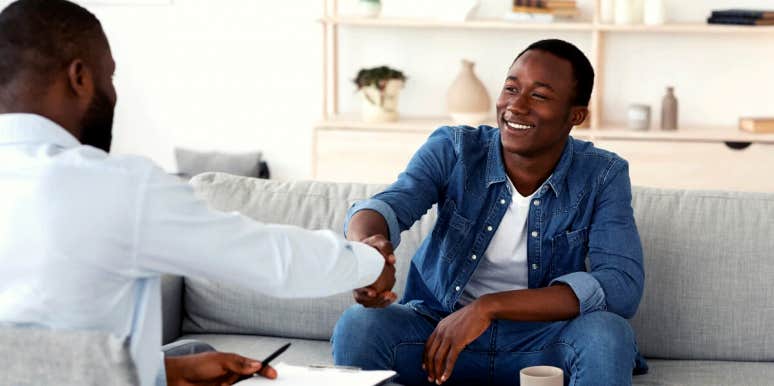man smiling as he shakes hands with his therapist
