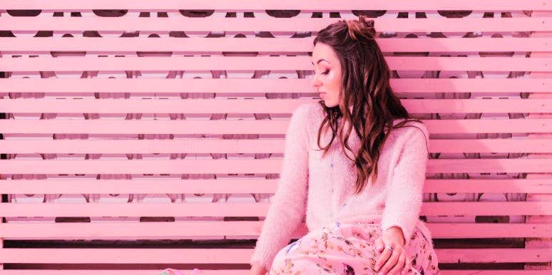 Does Baker-Miller Pink Work? Why Prisons Are Painted Pink woman leaning next to wall painted baker miller pink