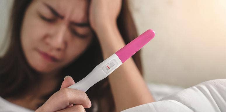 7 Crazy, Totally Unexpected Reasons So Many Women Can't Get Pregnant woman with a negative pregnancy test