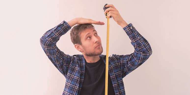 Why Tall People Are More Likely To Die Early man measuring his height