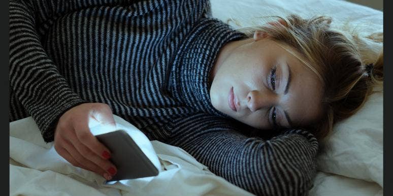 4 Reasons Why Texting Your Ex "Happy Birthday” Is A Terrible Idea woman thinking about texting her ex to say Happy Birthday