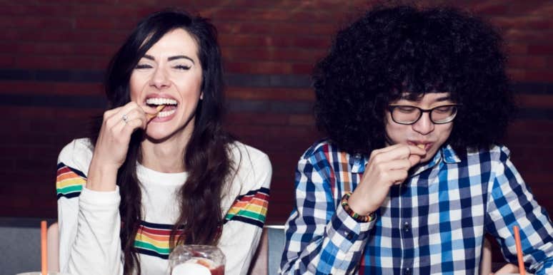 laughing couple eating french fries together