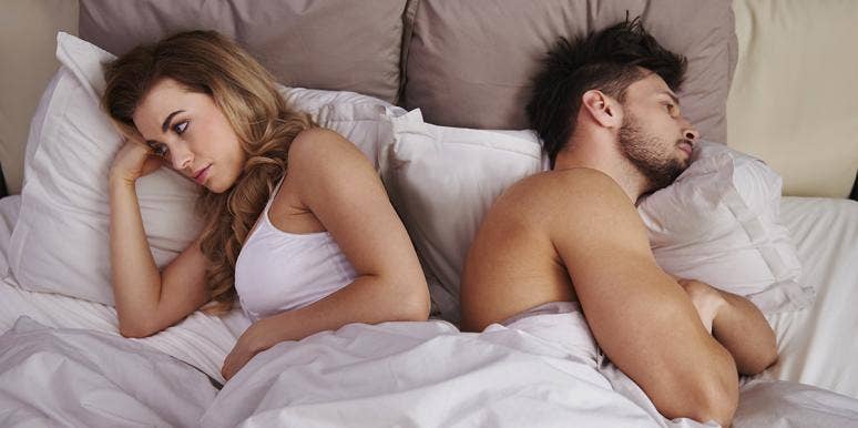 woman and man in opposite directions in bed