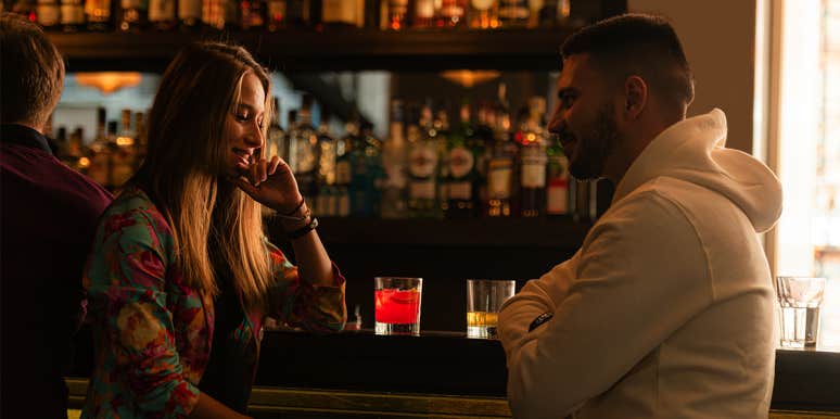 Why You Need To Stop Overthinking And Make The First Move man and woman sitting at bar