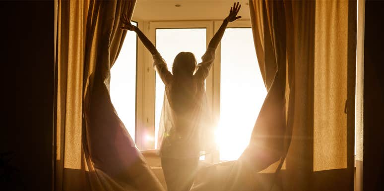 Why You Need To Wake Up And Appreciate The Sunrise woman opening curtains