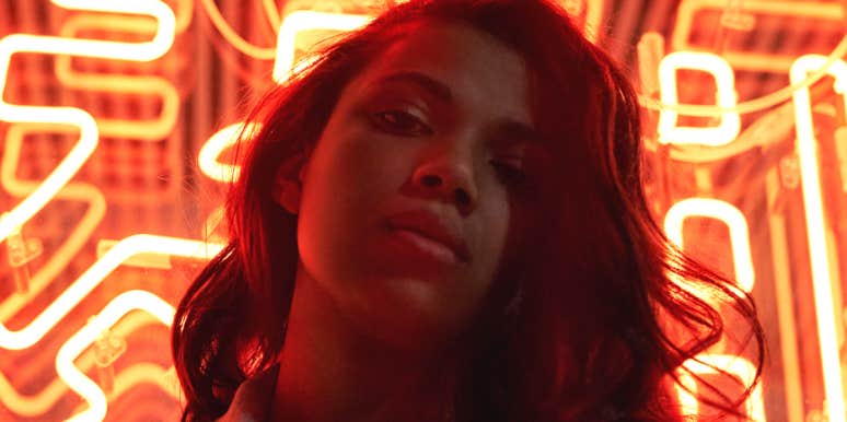 Why You Should Never Give The Advice That 'It's Just A Phase' woman posing in front of neon sign