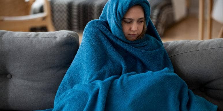 Why Am I Always Cold? 7 Possible Reasons, Tips & Solutions woman covering up