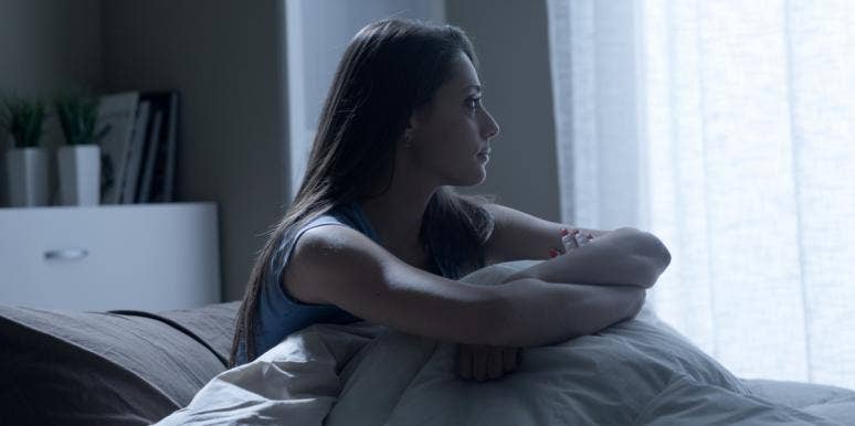 How Witnessing Domestic Violence Taught Me How Truly Common It Is sad woman in bed