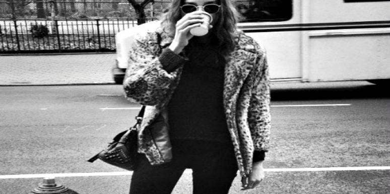 Woman drinking a hot beverage on the street. Woman drinking a hot beverage on the street.