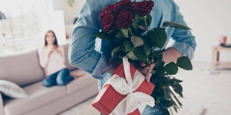 Woman Wonders If She Shouldn't Have Blown Up On Husband For Not Getting Her A Mother's Day Gift Husband with gift behind his back