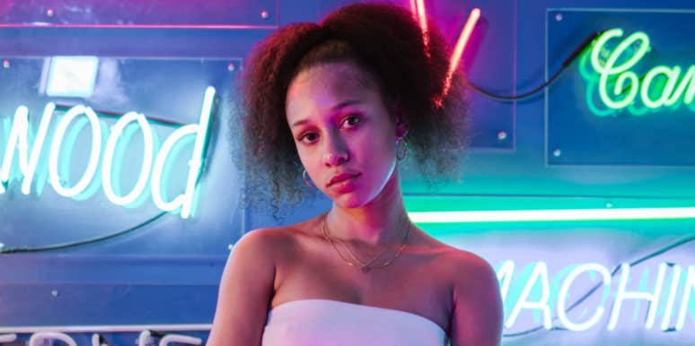 Woman Pretends Not To Recognize Her Parents Who Abandoned Her After They Approach Her To Reconnect Woman in front of neon sign
