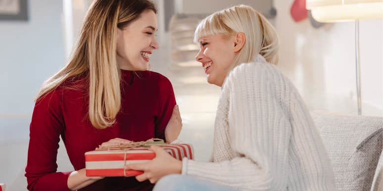 Two friends sharing gifts with each other. 