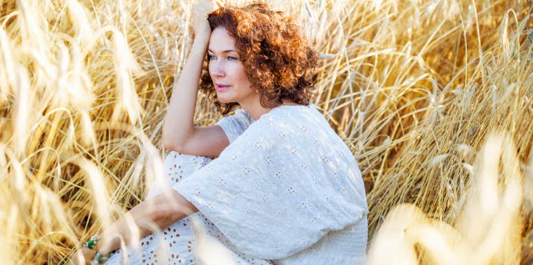 Mom Left Devastated After Daughter Reconnects With Abusive Father Woman sitting in field