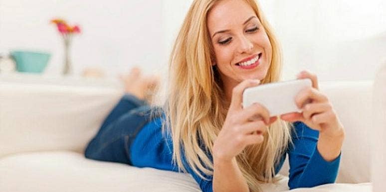 woman smiling and texting woman smiling and texting