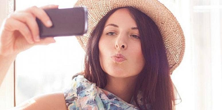 woman taking selfie in hat and scarf woman taking selfie in hat and scarf