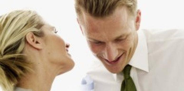 Flirting While Coupled: What Are The Rules? woman whispering in man's ear