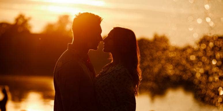 An Open Letter To The Girl Who Loves Too Hard couple embracing by lake