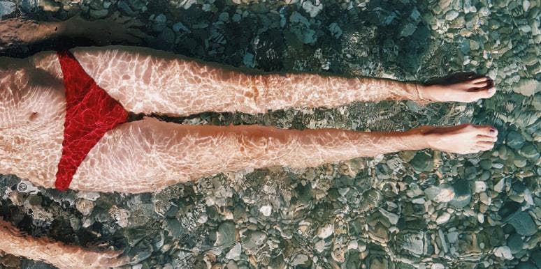 What The World's Most Scientifically Perfect Female Body Looks Like woman in bathing suit laying in water