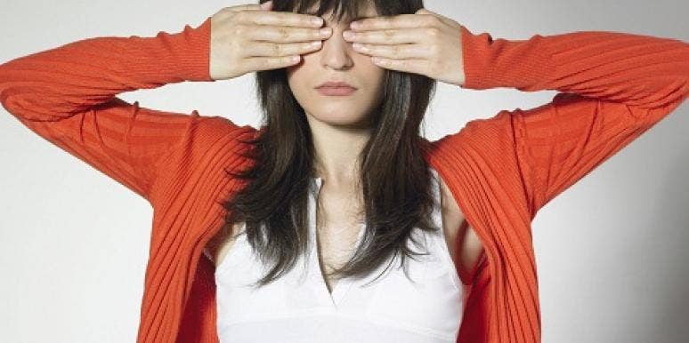 woman covering eyes woman covering eyes