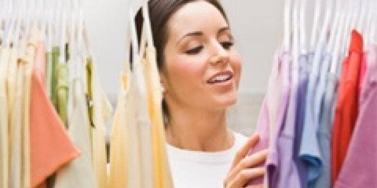 woman picking out clothes in closet