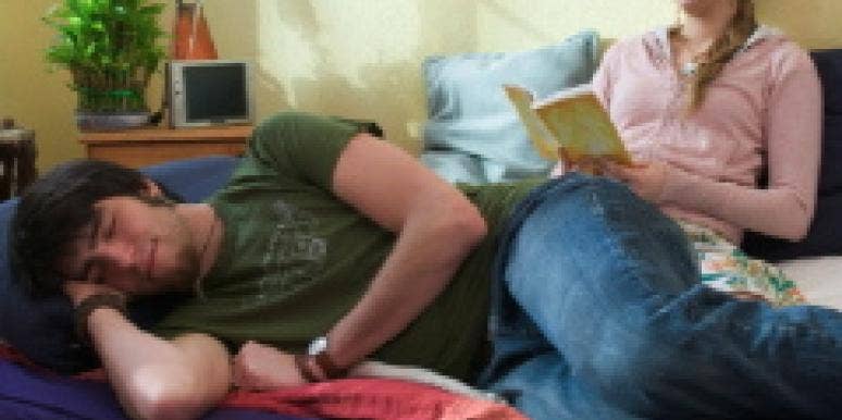 Woman reading while guy sleeps